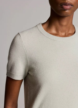A person wearing the Vince Relaxed Short Sleeve Crew Sweater in light beige, shown from the shoulders to mid-torso against a neutral background.