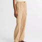 A person wears the vince Hemp Utility Pant with a sleeveless cream ribbed top and brown flat sandals, standing against a white background for a relaxed silhouette.