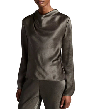 A person is wearing the Vince Long Sleeve Draped Cowl Blouse in olive green with matching pants, featuring a pleated neckline, and standing against a plain white background.