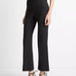 A person wearing Vince’s Niki Mid Rise Crop Flare Pant in black Italian cotton-blend, featuring pintuck legs, paired with black pointed-toe ankle-strap shoes and standing against a plain white background.