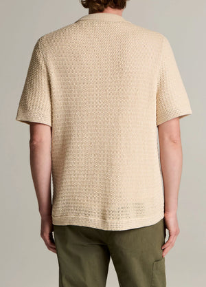 A person is shown from the back against a plain background, wearing the vince Crochet SS Button Down in beige with olive green pants.