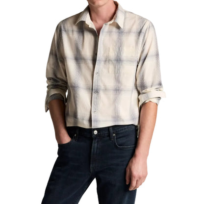 A person wearing the vince Townes Plaid Long Sleeve Shirt with rolled-up sleeves and dark jeans stands with one hand in their pocket.
