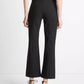 A person facing away wears black vince Niki Mid Rise Crop Flare Pants with pintuck legs and black heeled sandals with ankle ties, standing against a white background.