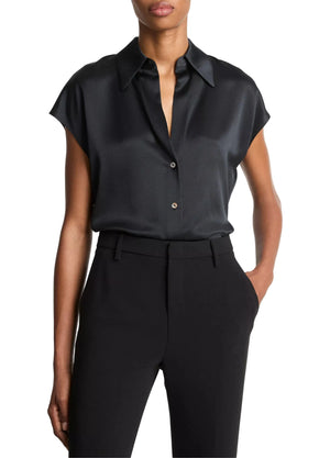 A person wearing the vince Cap Sleeve Silk Blouse in black, styled slim and tucked into high-waisted black pants with one hand in a pocket; head not fully visible.