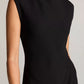 A model wears the vince Draped Funnel Neck Dress—a sleeveless black design with a high neckline—shown from the shoulders to mid-thigh against a neutral background.
