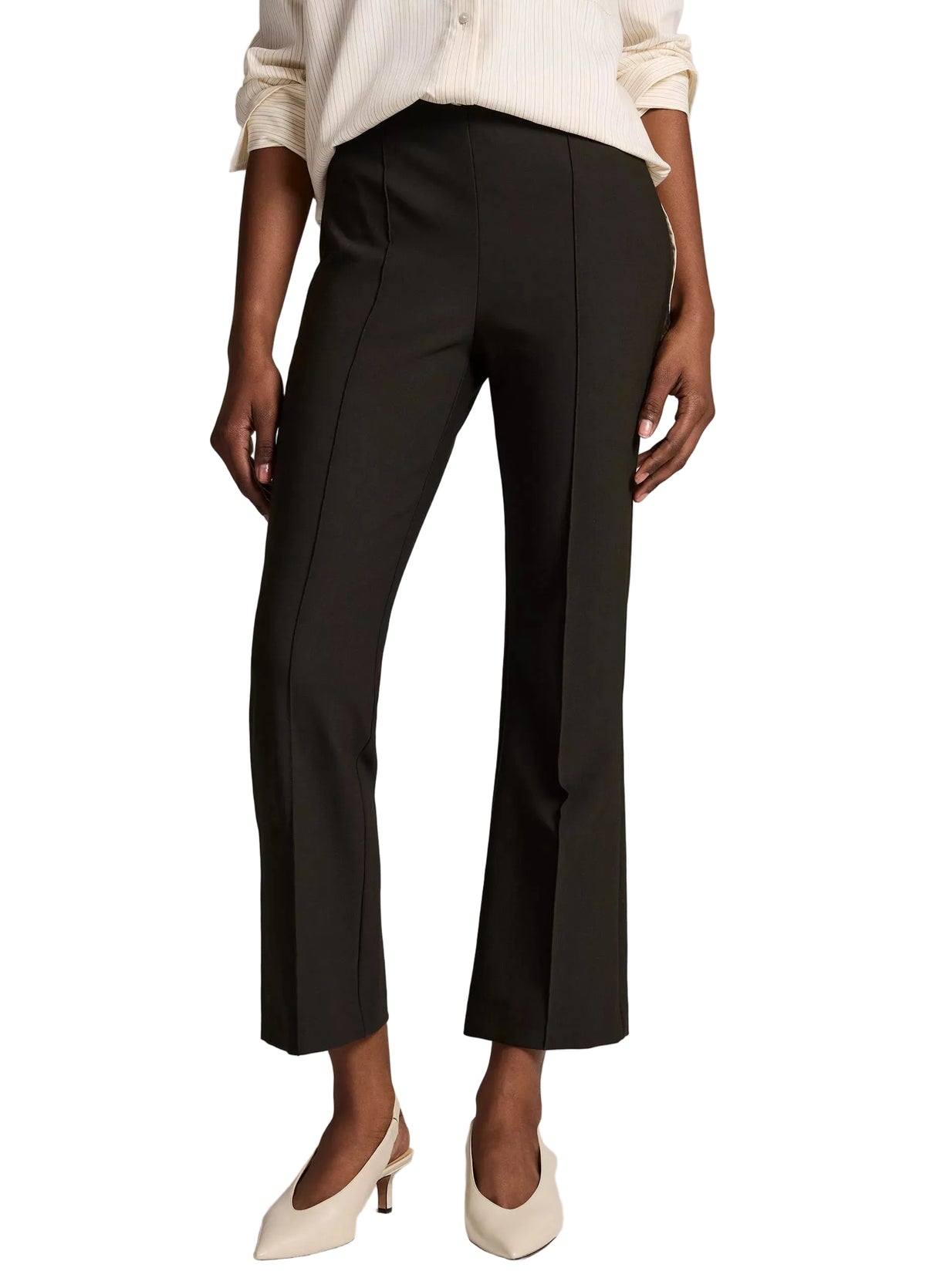 Black Vince Niki Mid Rise Crop Flare Pants in a bi-stretch fabric with a center seam, worn with a white long-sleeve shirt and beige pointed-toe heels.