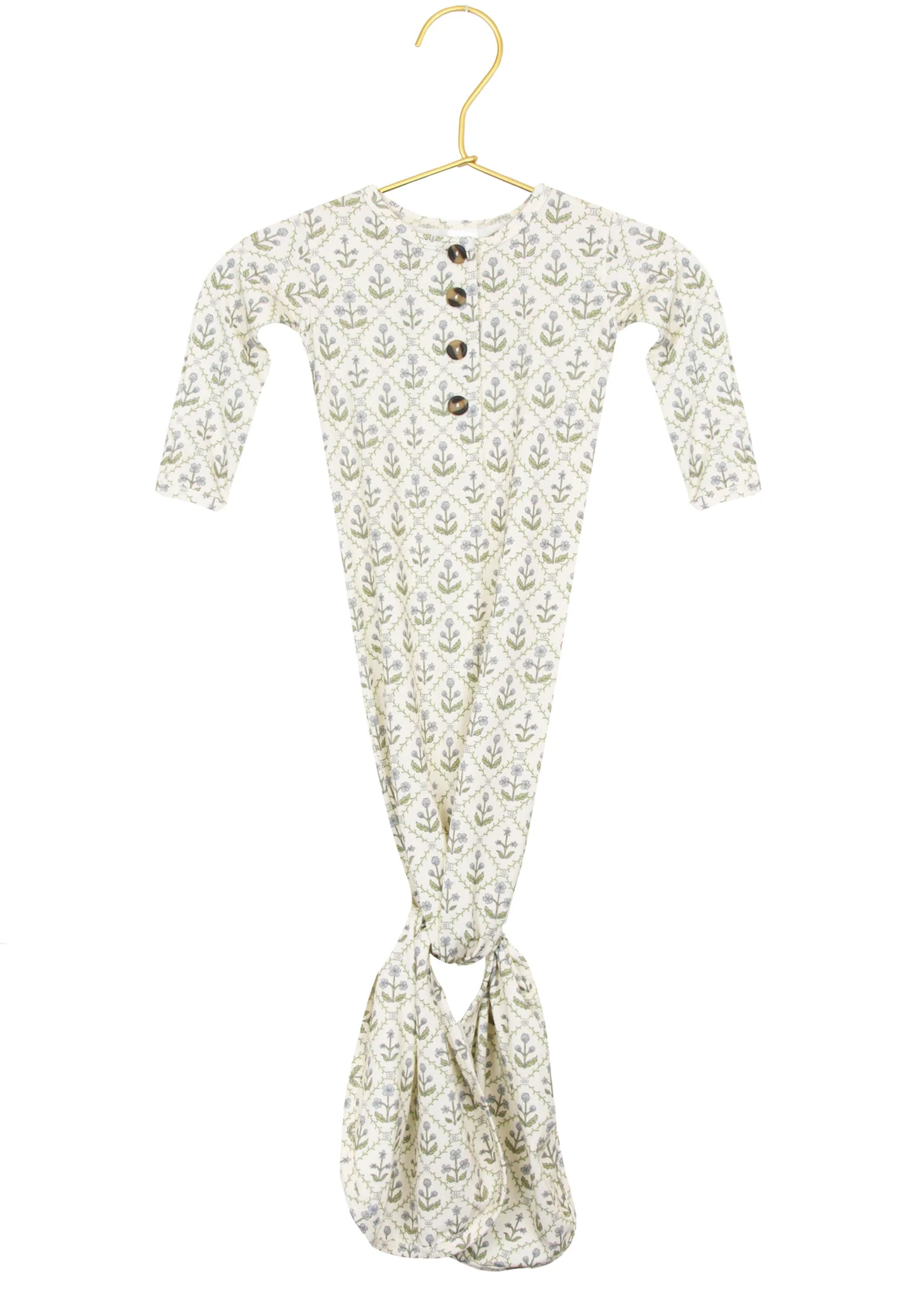 The Lou Lou & Company Baby Girls’ Etta Knotted Gown features long sleeves, a leafy pattern, a buttoned neckline, and a knotted bottom for easy diaper changes, shown on a gold hanger against a white background.