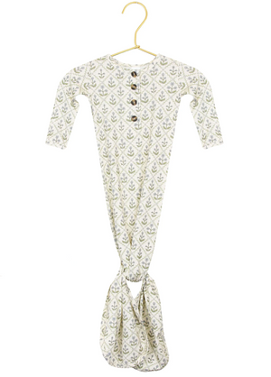 The Lou Lou & Company Baby Girls’ Etta Knotted Gown features long sleeves, a leafy pattern, a buttoned neckline, and a knotted bottom for easy diaper changes, shown on a gold hanger against a white background.