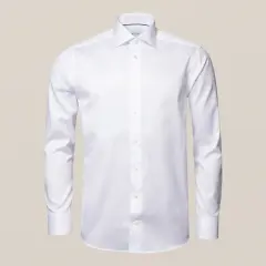 The Eton White Signature Twill Shirt, Contemporary Fit features a classic collar and long sleeves in wrinkle-free fabric, showcased against a beige background—a timeless display of elegance.
