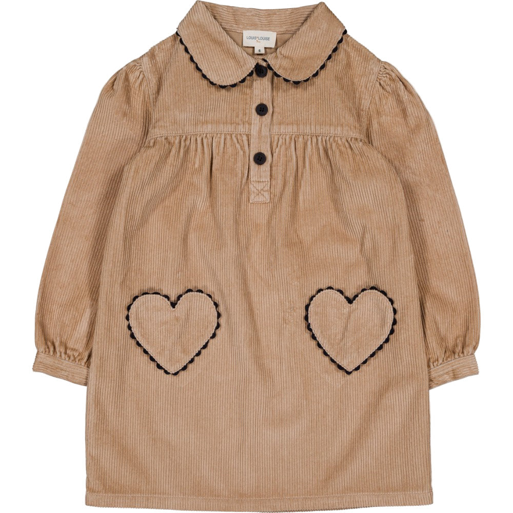 The Girls' Belinda Big Corduroy Dress by Louis Louise features long sleeves, a tan corduroy design, Peter Pan collar, black buttons, and two heart-shaped pockets outlined in black stitching.