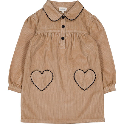 The Girls' Belinda Big Corduroy Dress by Louis Louise features long sleeves, a tan corduroy design, Peter Pan collar, black buttons, and two heart-shaped pockets outlined in black stitching.