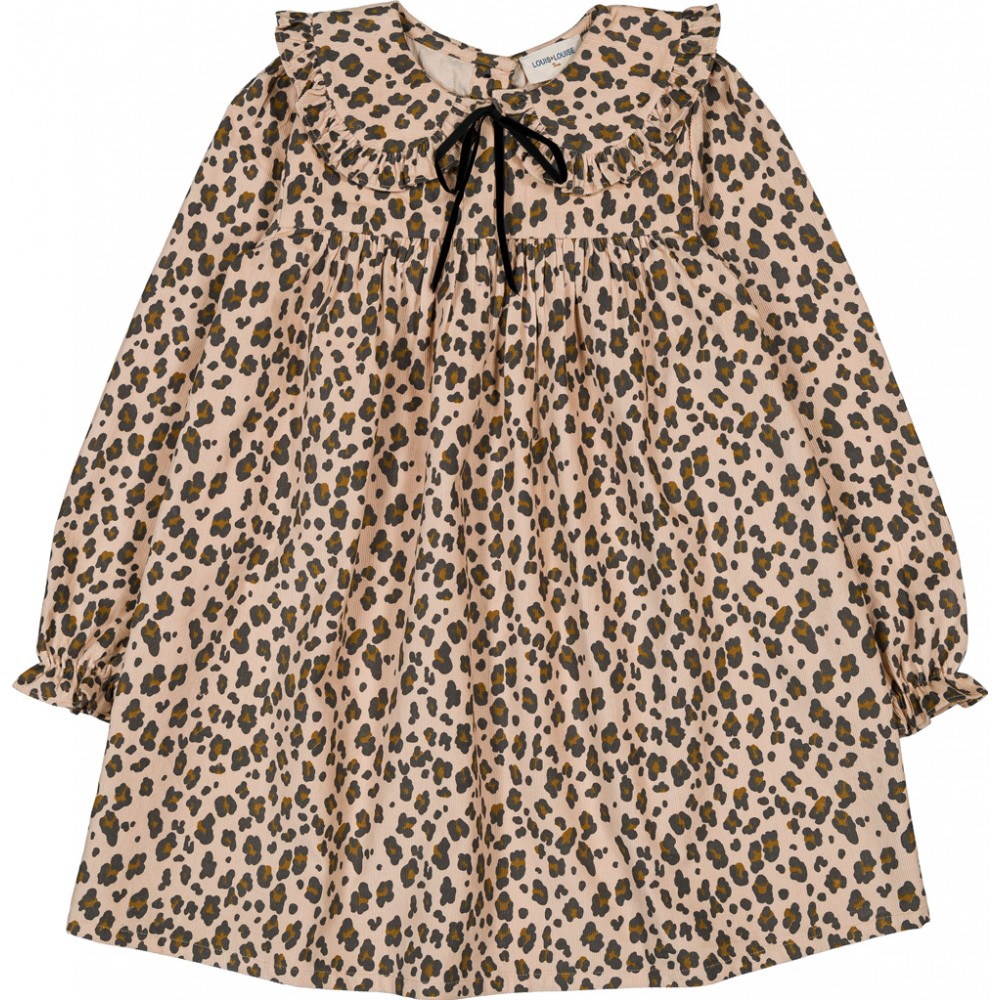 The Girls' Benjamine Corduroy Leopary Dress by Louis Louise features a beige background with brown and black leopard print, long sleeves, Peter Pan collar with ruffle details, and a black ribbon tie at the neckline.