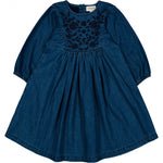 The Girls' Mahana Light Denim Dress by Louis Louise features long sleeves, a button placket, chest floral embroidery, and a gathered skirt for easy style.