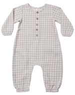 The Quincy Mae Baby Boys’ Woven Jumpsuit is a gray and white plaid long sleeve one-piece for babies, made from soft organic cotton gauze. Featuring four front buttons and elastic cuffs at the wrists and ankles, this jumpsuit is displayed laid flat on a white background.