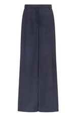 The Taite Pant by TWP features wide-leg navy blue 100% linen, a high waist, belt loops, and a concealed front closure, displayed against a plain white background.