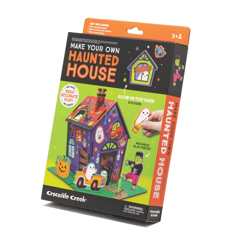 The Crocodile Creek Make Your Own Haunted House craft kit, shown in its product box with glow-in-the-dark stickers and pop-in play figurines.