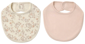Here’s a rewritten version using the provided product data: The Quincy Mae Jersey Snap Bib, 2-Pack features two baby bibs side by side: one made from soft brushed jersey with a charming floral print on a cream background, and the other in a solid pale pink. Both bibs are designed with convenient snap closures at the back of the neck for easy dressing.