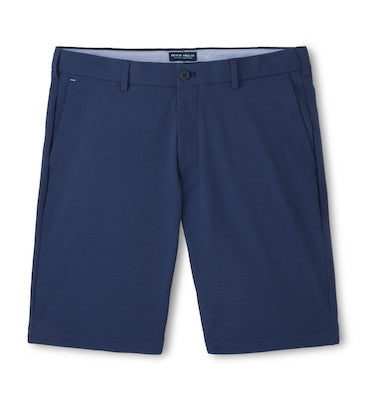 The Peter Millar Matlock Seersucker Performance Short in navy, knee-length with belt loops, front pockets, and a button closure is shown laid flat on a white background.