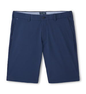 The Peter Millar Matlock Seersucker Performance Short in navy, knee-length with belt loops, front pockets, and a button closure is shown laid flat on a white background.