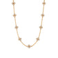 The Juliska Capucine De Wulf Berry Clover Double Sided Necklace features evenly spaced floral-shaped clusters with small round white stones set on a fine gold chain.