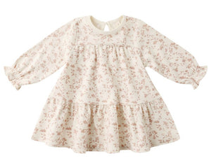 The Quincy Mae Baby Girls' and Girls' Tiered Jersey Dress features long sleeves, a cream color with a light pink floral pattern, a ruffled skirt, and gathered cuffs.
