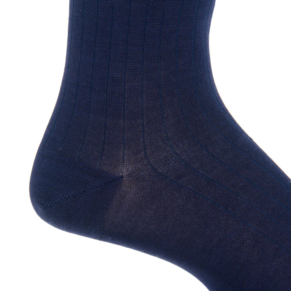 Close-up of Dapper Classics’ Classic Navy Ribbed Mid Calf Sock worn on a foot, highlighting the heel and lower leg. These durable socks are designed to maintain their shape and offer lasting comfort all day.