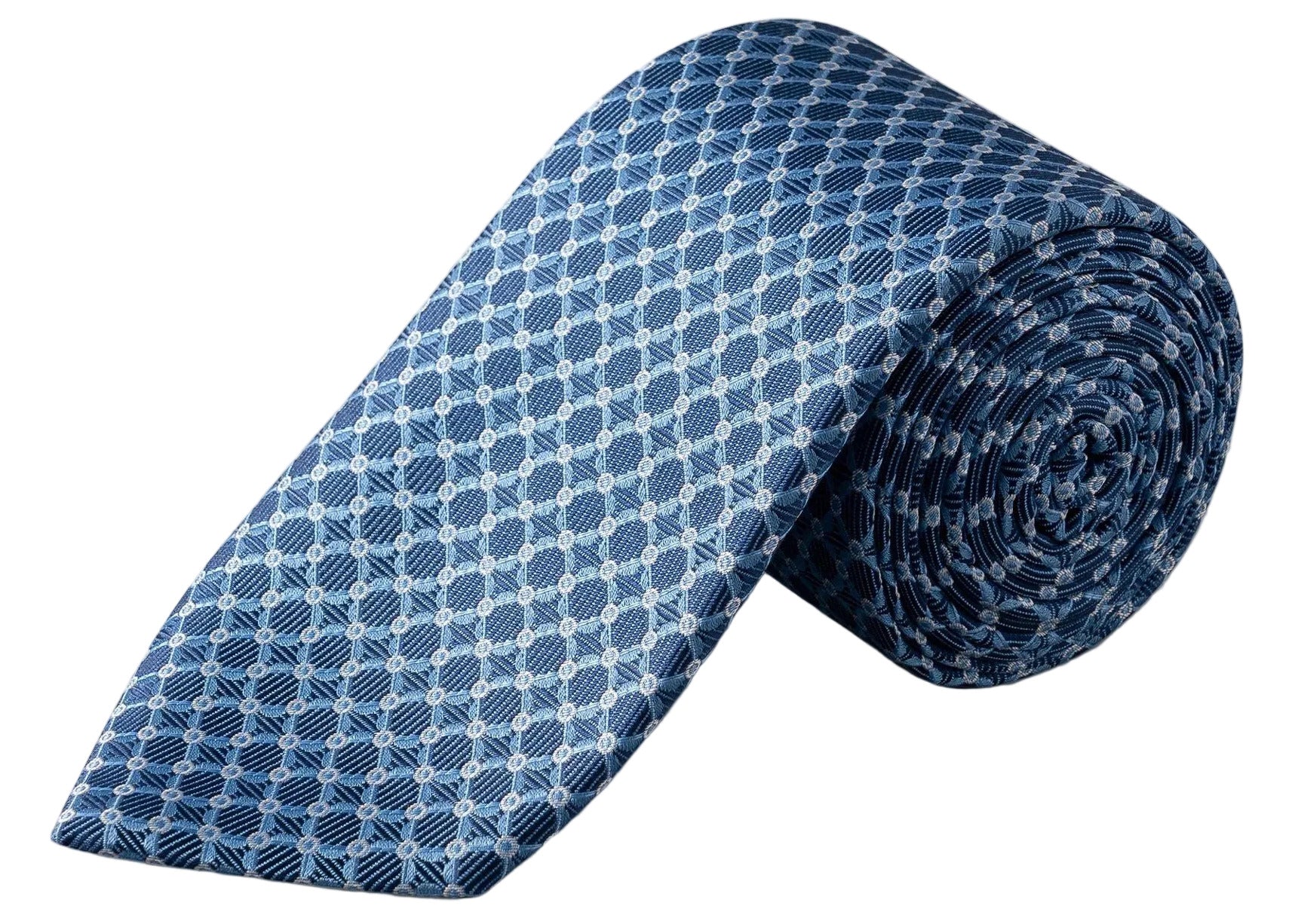 The Eton Geometric Woven Silk Tie, featuring a sophisticated blue jacquard weave with white and navy geometric patterns, is elegantly displayed rolled up on a white background—an ideal accessory to elevate any formal occasion.