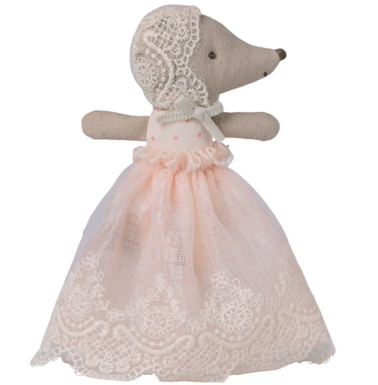 Maileg's Baby Mouse in Powder Gown features a double-sided face, a lace bonnet, and a powder pink skirt with a delicate lace overlay, standing upright against a white background.