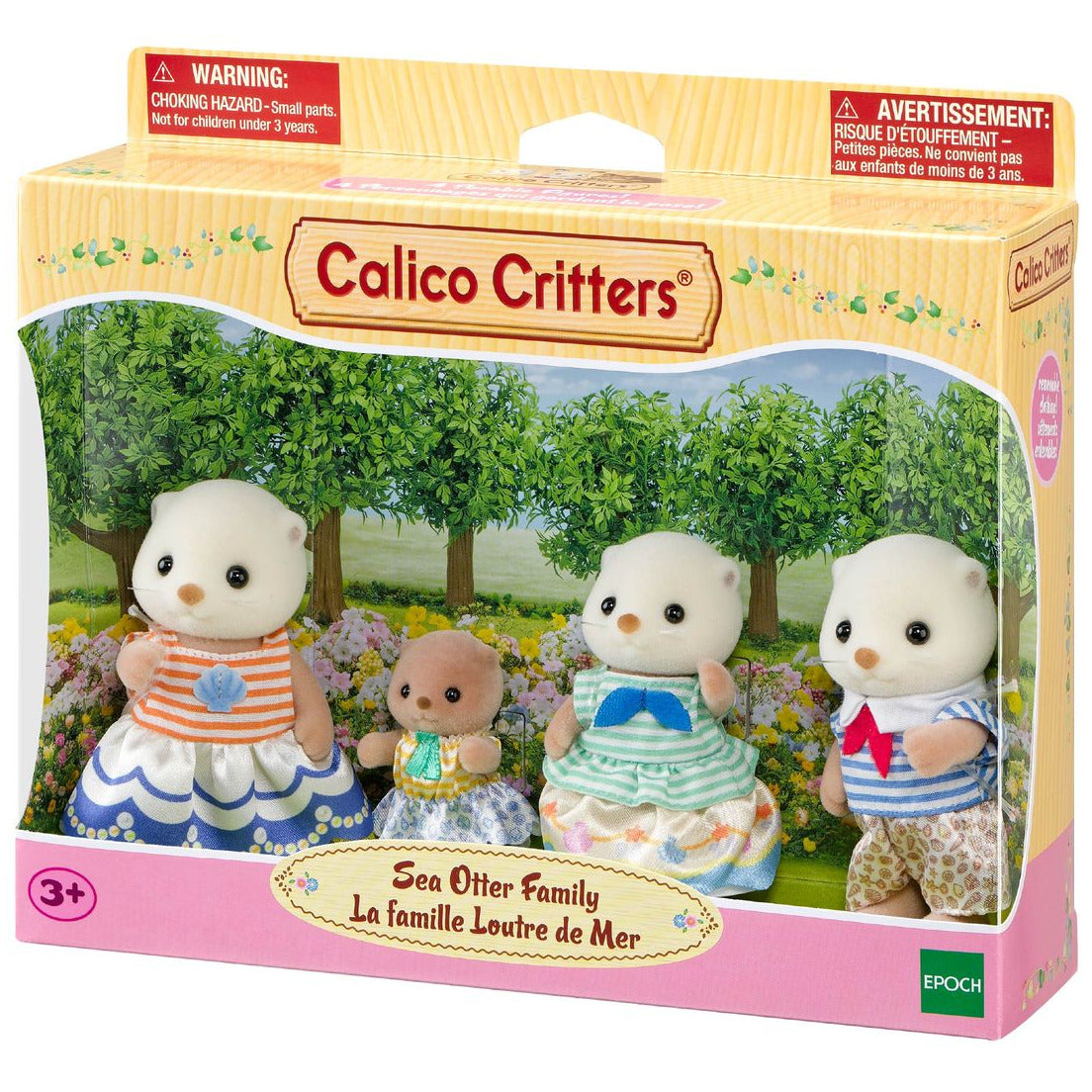 The Calico Critters Sea Otter Family toy set includes four plush otter figures dressed in charming fabric outfits with a subtle shell motif, attractively displayed outdoors on the packaging.