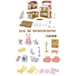 The Calico Critters Red Roof Country Home Gift Set includes assembled house pieces, animal figurines, furniture, small accessories, and beds all arranged neatly on a white background.