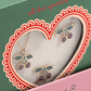 Konges Slojd Jewelery Set features cherry-shaped necklace and earrings with gold outlines, green leaves, and red cherries in a heart-shaped box window.