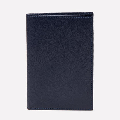 An upright Ettinger Capra Passport Case in closed, dark blue Capra leather is displayed against a plain white background.