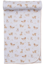 The Kissy Kissy Puppy Paws Printed Blanket is made of white Pima cotton and features a soft fabric adorned with small, cartoon-style brown and beige dogs in various poses, along with light brown puppy paws scattered across the design.
