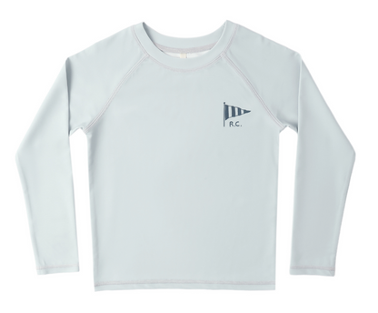 The Rylee & Cru Baby Boys' and Boys' Long Sleeve Rashguard is light gray with a small navy striped pennant and "R.C." on the left chest. It offers UPF 50+ protection, ideal for beach play, and is shown on a plain white background.