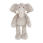 Edgar Elephant by Mon Ami is a plush gray elephant toy featuring large ears, a trunk, white tusks, and textured fur, standing upright against a white background.
