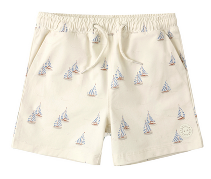 Rylee & Cru Baby Boys' and Boys' Boardshort in beige, with blue, red, and white sailboat pattern and drawstring waist. Provides UPF 50+ sun protection—stylish and comfortable swimwear.
