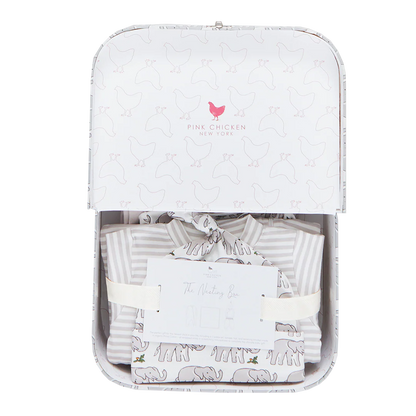 The Pink Chicken Nesting Box Baby Take Home Set features folded striped and animal-print organic pima cotton baby clothing, presented in a gift box with ribbon and card—perfect for newborns.