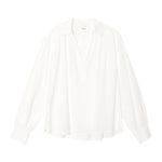 The Elena Top by Xirena is a loose-fitting, long-sleeve white popover with a Johnny collar and V-neck, made from lightweight cotton poplin, shown against a plain white background.