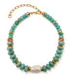 The Provence Necklace by Lizzie Fortunato features beaded green stones reminiscent of an amazonite collar necklace, accented with gold spacer beads, coral-colored details, a large central baroque pearl, and finished with a gold adjustable clasp.