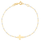 The Gigi Clozeau Classic Cross Charm Bracelet 6.7" features an 18k gold chain, elegant resin pearls, and a central cross charm, offering a timeless design.