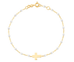 The Gigi Clozeau Classic Cross Charm Bracelet 6.7" features an 18k gold chain, elegant resin pearls, and a central cross charm, offering a timeless design.