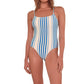 A person wearing the lemlem Elene One Piece by Lemlem, featuring blue and white vertical stripes and adjustable spaghetti straps.