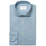 The Eton Slim Wide Spread Solid Signature Flannel Shirt, in light blue cotton with white buttons and a spread collar, is neatly folded and displayed on a white background—ideal for stylish cold-weather wear.