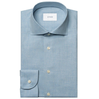 The Eton Slim Wide Spread Solid Signature Flannel Shirt, in light blue cotton with white buttons and a spread collar, is neatly folded and displayed on a white background—ideal for stylish cold-weather wear.