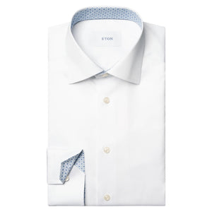 The Eton White Signature Twill Shirt features a slim cut away collar, blue patterned contrast cuffs and inner collar, white buttons, and the brand label inside.