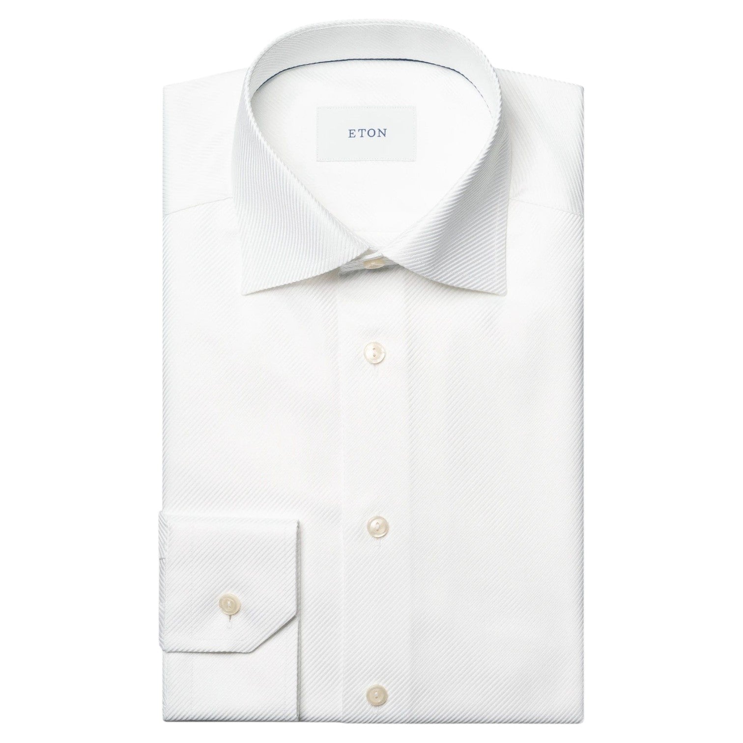 The Eton Solid King Twill Shirt is a white, wrinkle-resistant dress shirt with a pointed collar and buttoned cuffs—designed for lasting sophistication.