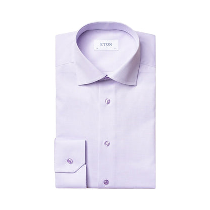 A neatly folded Solid Signature Oxford Shirt by Eton in light purple cotton, featuring a spread collar and buttoned cuffs, displayed on a plain white background.
