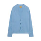 The Everywear Cardigan by Guest in Residence is a light blue cashmere V-neck sweater with three front buttons and long sleeves, shown on a plain white background.