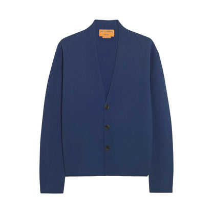 The Everywear Cardigan by Guest in Residence is a deep blue cashmere piece with long sleeves and a V-neck, shown against a white background.