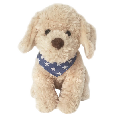 Bentley the Golden Doodle by Mon Ami sits upright against a white background, wearing a blue star bandana and showing off its cute beige fur.